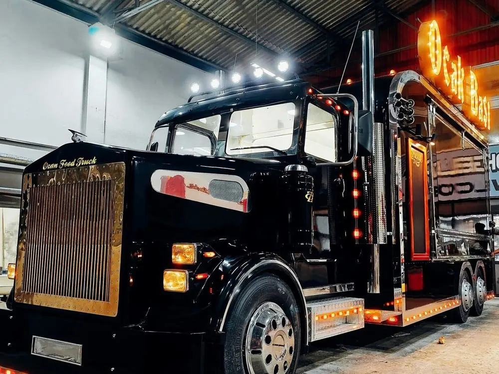 Ocak Başı custom grill truck on an American-style tractor unit, lit at night