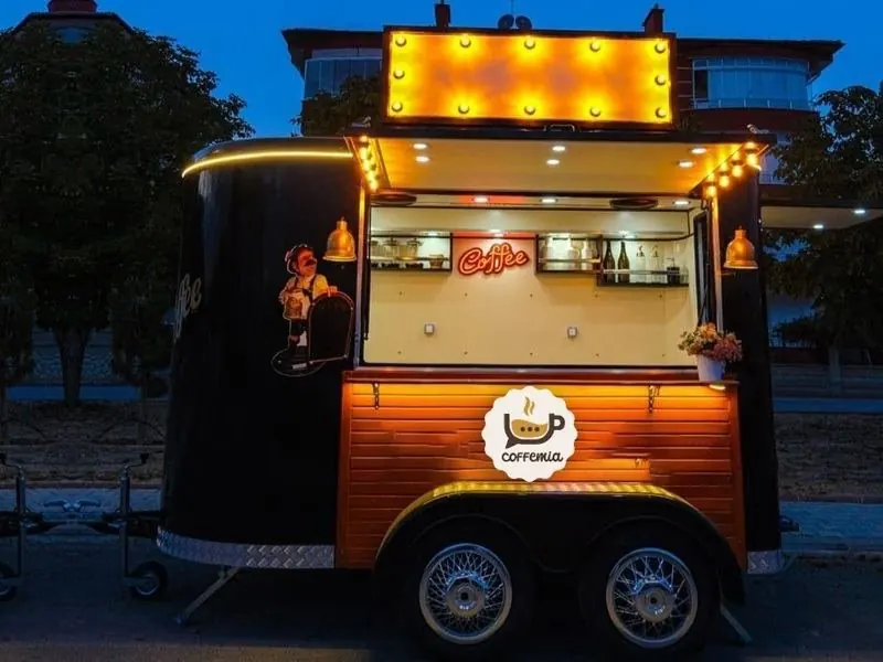 Coffomus coffee trailer lit at night