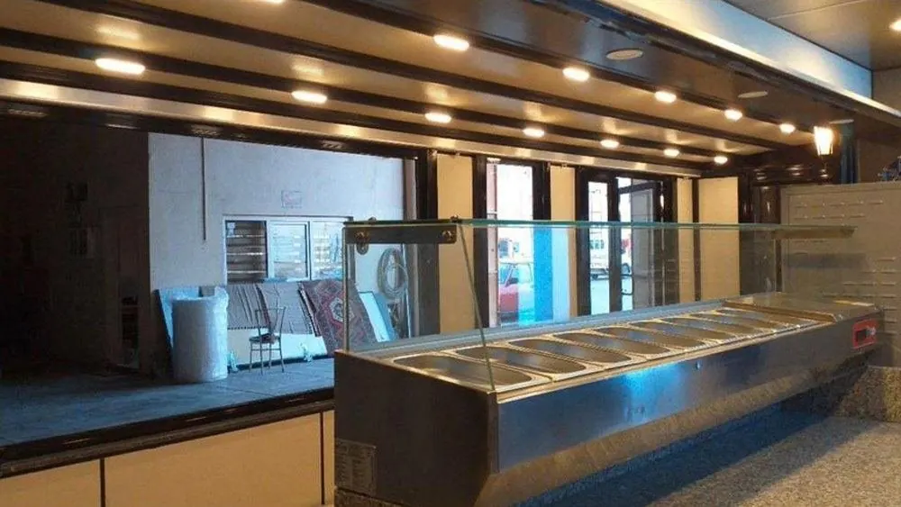 Lit bain-marie serving counter inside a container restaurant